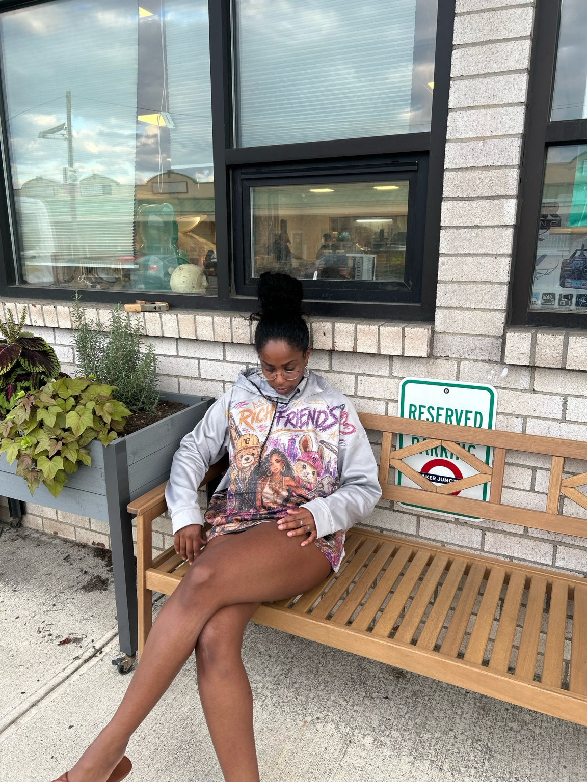 ITT TOLD'EM Rich Friends hoodie worn outdoors, seated view