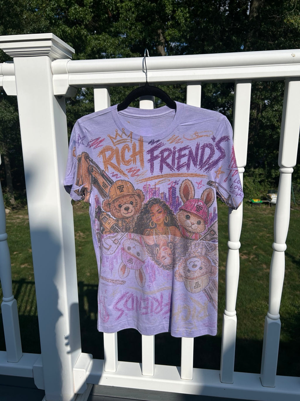 ITT TOLD'EM Rich Friends all-over graphic T-shirt, outdoor angled view