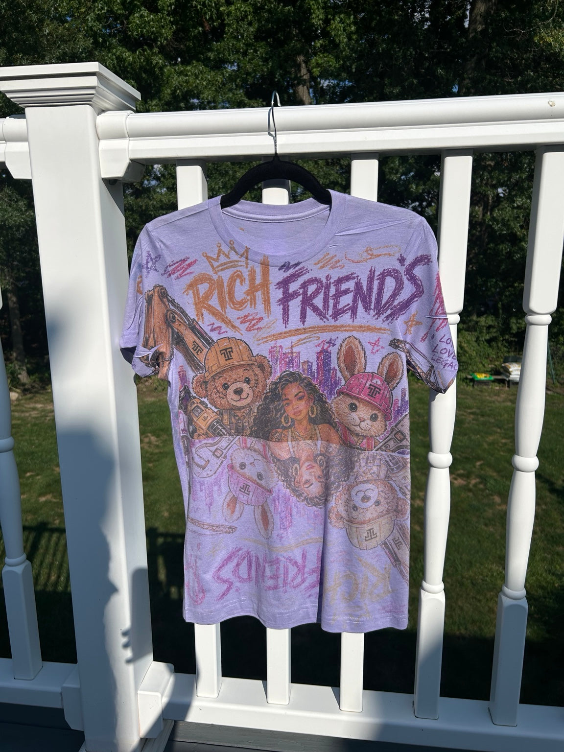 ITT TOLD'EM Rich Friends all-over graphic T-shirt, outdoor angled view